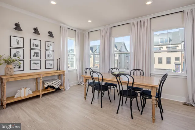 a view of a dining room with furniture window and wooden floor