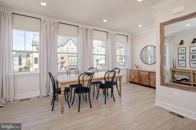 a view of a a dining room with furniture window and wooden floor