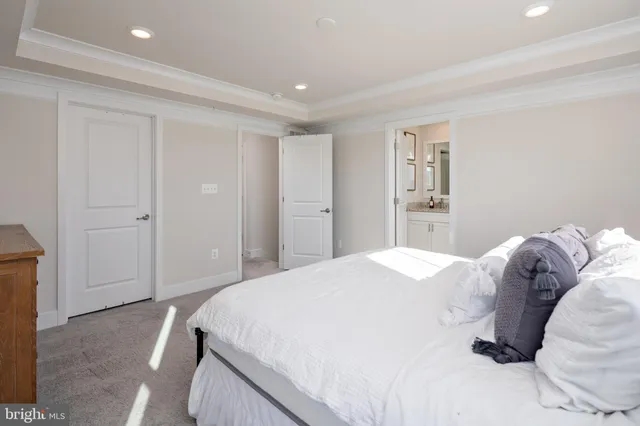 a spacious bedroom with a bed and a cabinets