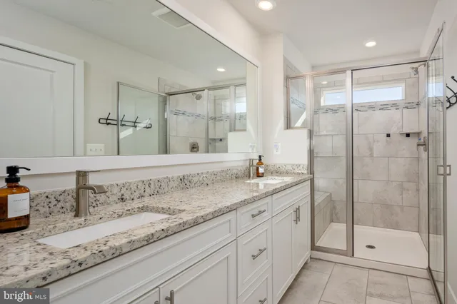 a bathroom with a granite countertop sink mirror and double