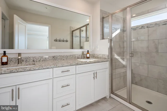 a bathroom with a granite countertop sink mirror and double