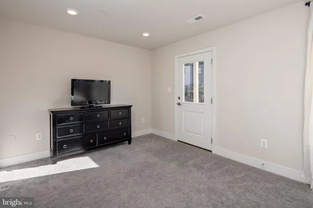 a spacious bedroom with a bed and a window