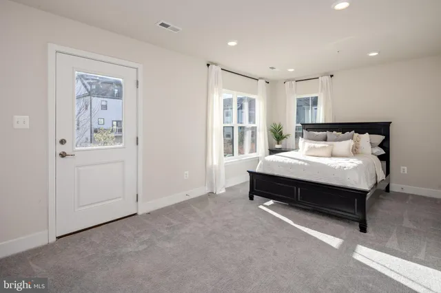 a spacious bedroom with a bed and a view of bathroom