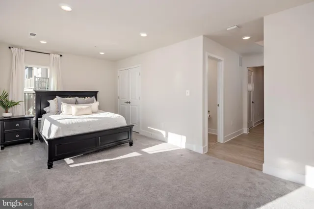 a front view of a building with large trees