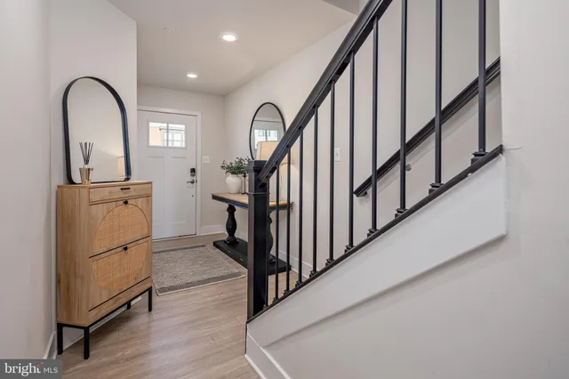 a view of a livingroom with wooden floor and furniture
