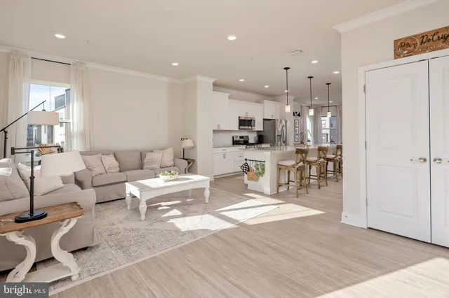 a living room with lots of furniture and kitchen view