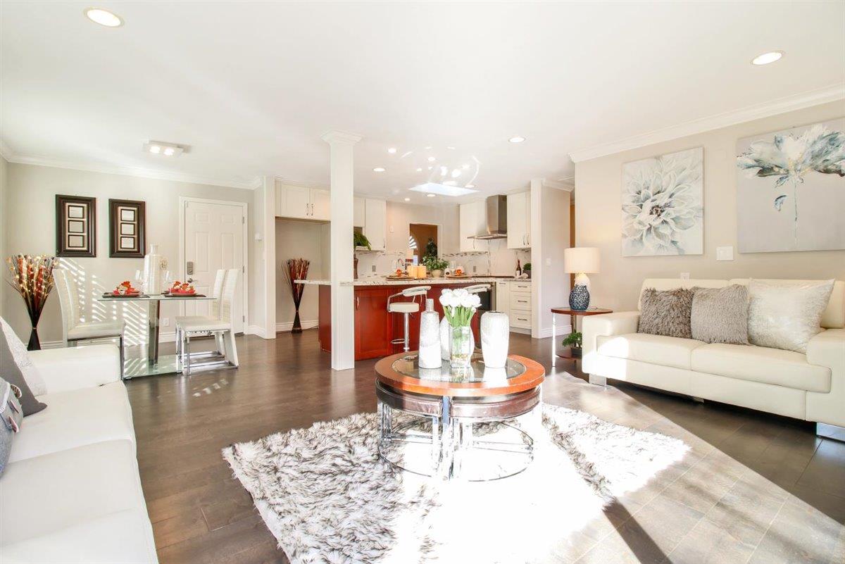 10846 Willowbrook Way Cupertino, CA 95014 - Photo 16 of 48 a living room with furniture and a dining table with wooden floor