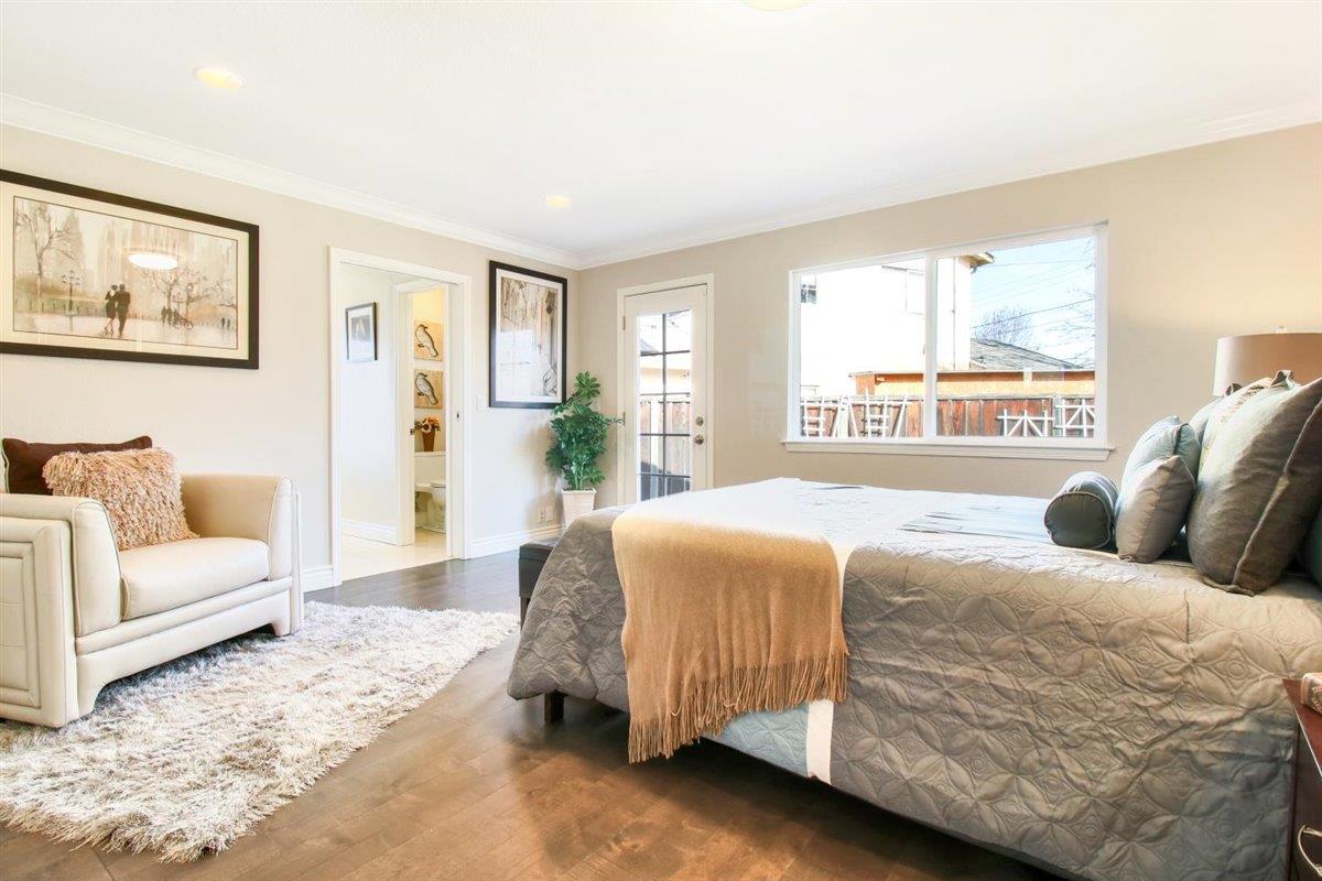 10846 Willowbrook Way Cupertino, CA 95014 - Photo 17 of 48 a bedroom with a large bed couch and a large window