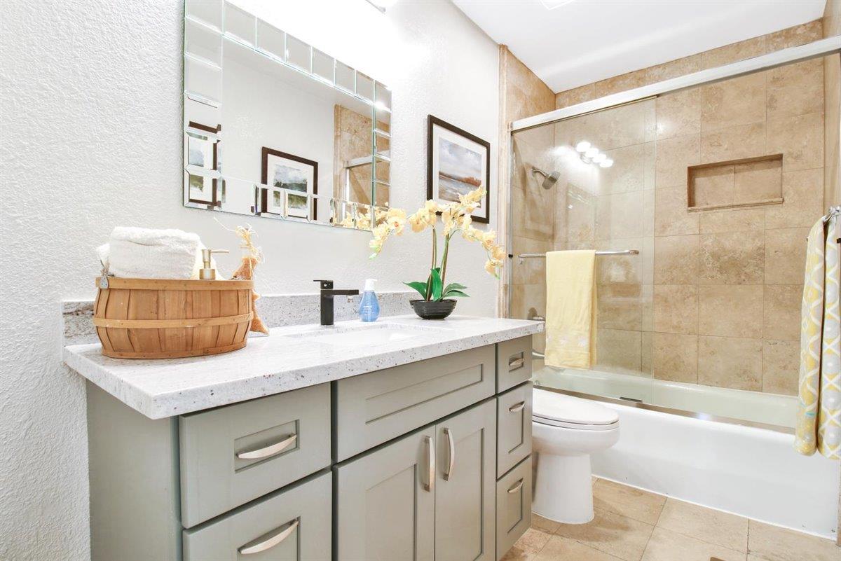 10846 Willowbrook Way Cupertino, CA 95014 - Photo 27 of 48 a bathroom with a granite countertop sink a toilet and shower