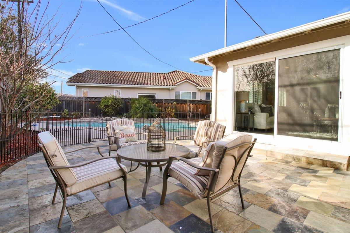 10846 Willowbrook Way Cupertino, CA 95014 - Photo 38 of 48 a view of a patio with a table and chairs under an umbrella
