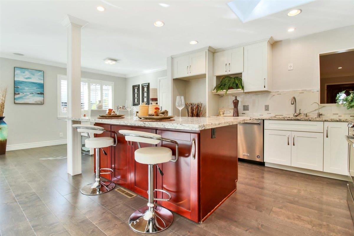 10846 Willowbrook Way Cupertino, CA 95014 - Photo 7 of 48 a kitchen with stainless steel appliances granite countertop a table chairs sink and cabinets
