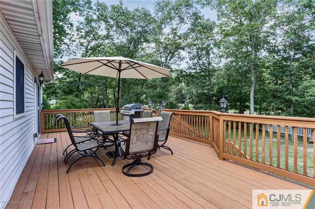97 Hickory Hill Road Jackson, NJ 08527 - Photo 22 of 24 a view of balcony with outdoor seating and wooden floor