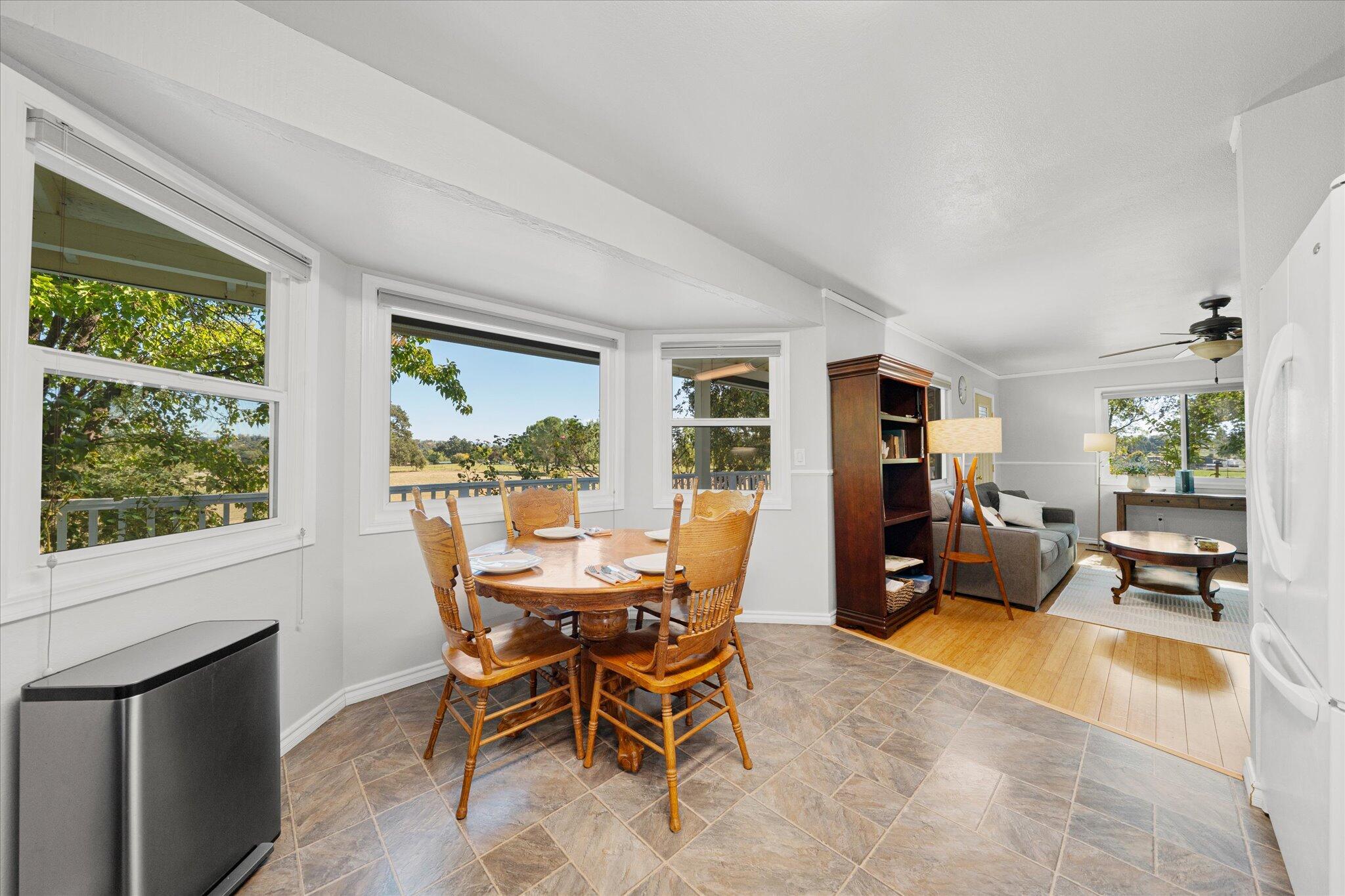 10241 Deschutes Road Palo Cedro, CA 96073 - Photo 18 of 56 a dining room with furniture and large windows