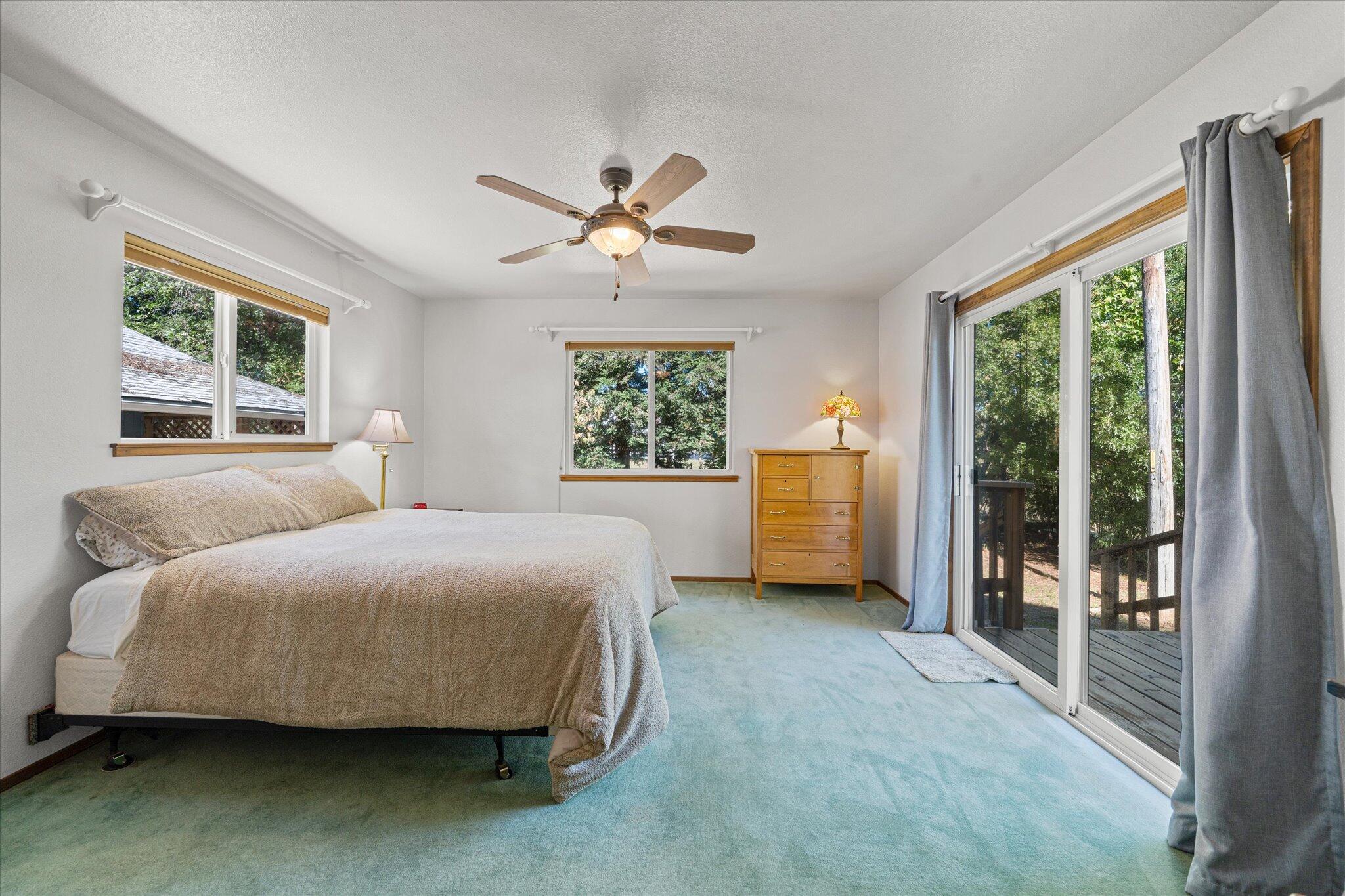 10241 Deschutes Road Palo Cedro, CA 96073 - Photo 19 of 56 a bedroom with a large bed and a large window