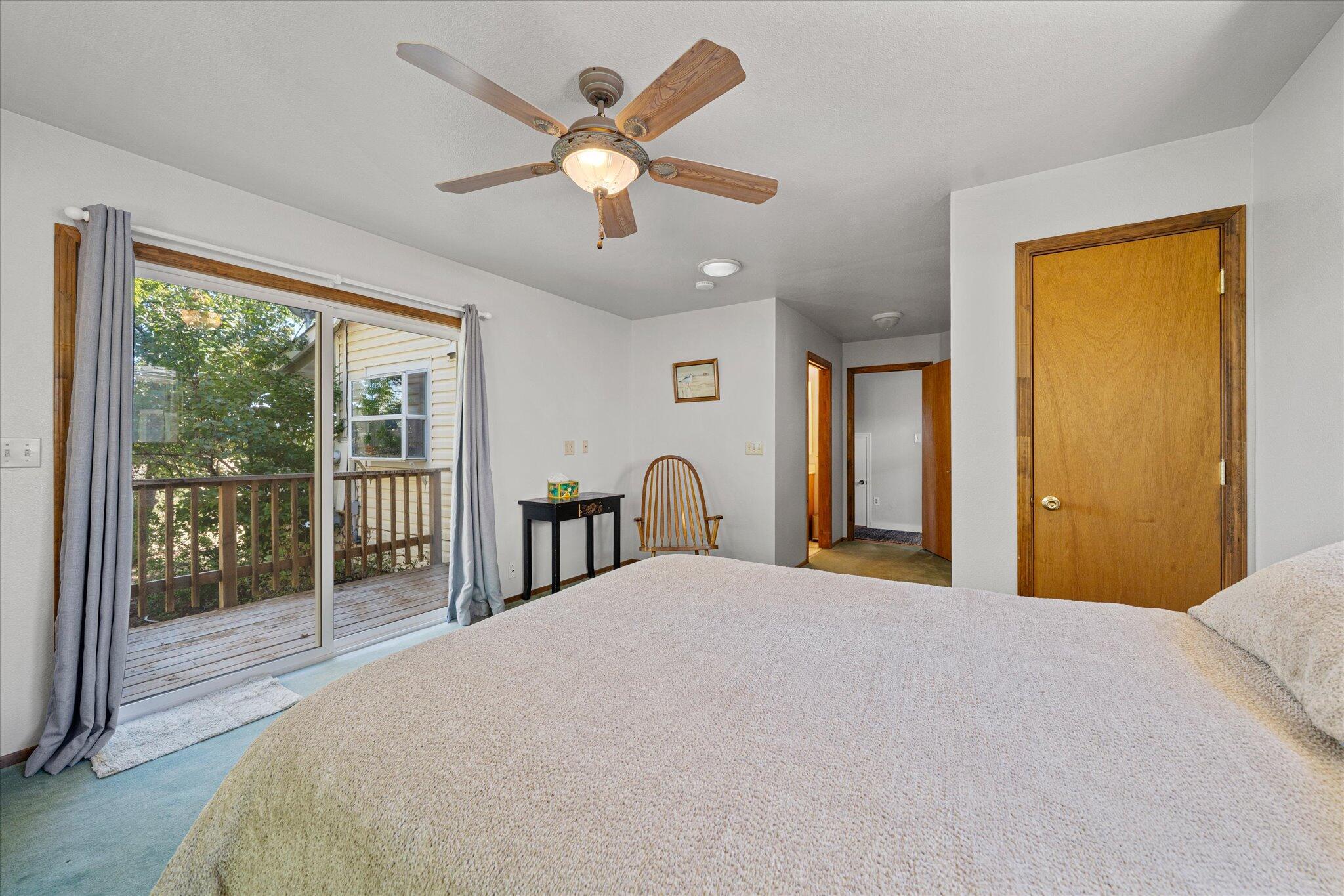 10241 Deschutes Road Palo Cedro, CA 96073 - Photo 20 of 56 a bedroom with a large bed and a large window