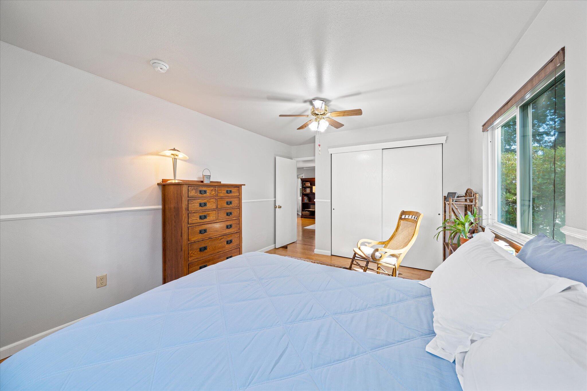 10241 Deschutes Road Palo Cedro, CA 96073 - Photo 22 of 56 a bed room with a bed and a chandelier