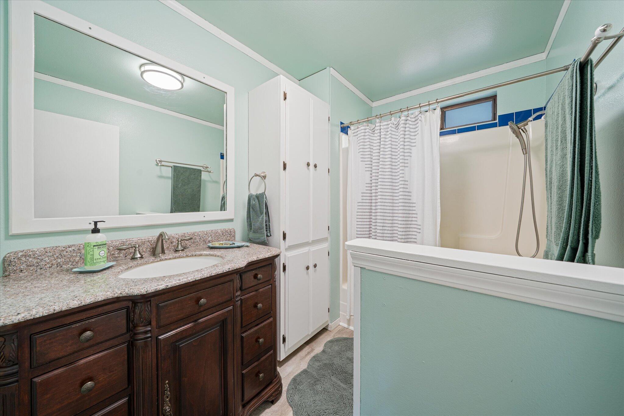 10241 Deschutes Road Palo Cedro, CA 96073 - Photo 23 of 56 a bathroom with a granite countertop sink and a mirror