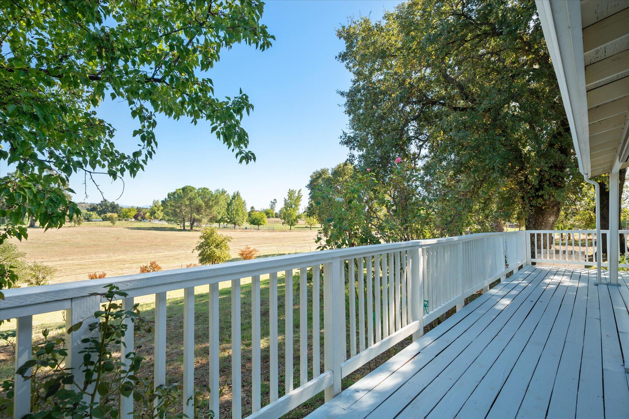 10241 Deschutes Road Palo Cedro, CA 96073 - Photo 32 of 56 a view of a balcony with wooden floor and fence
