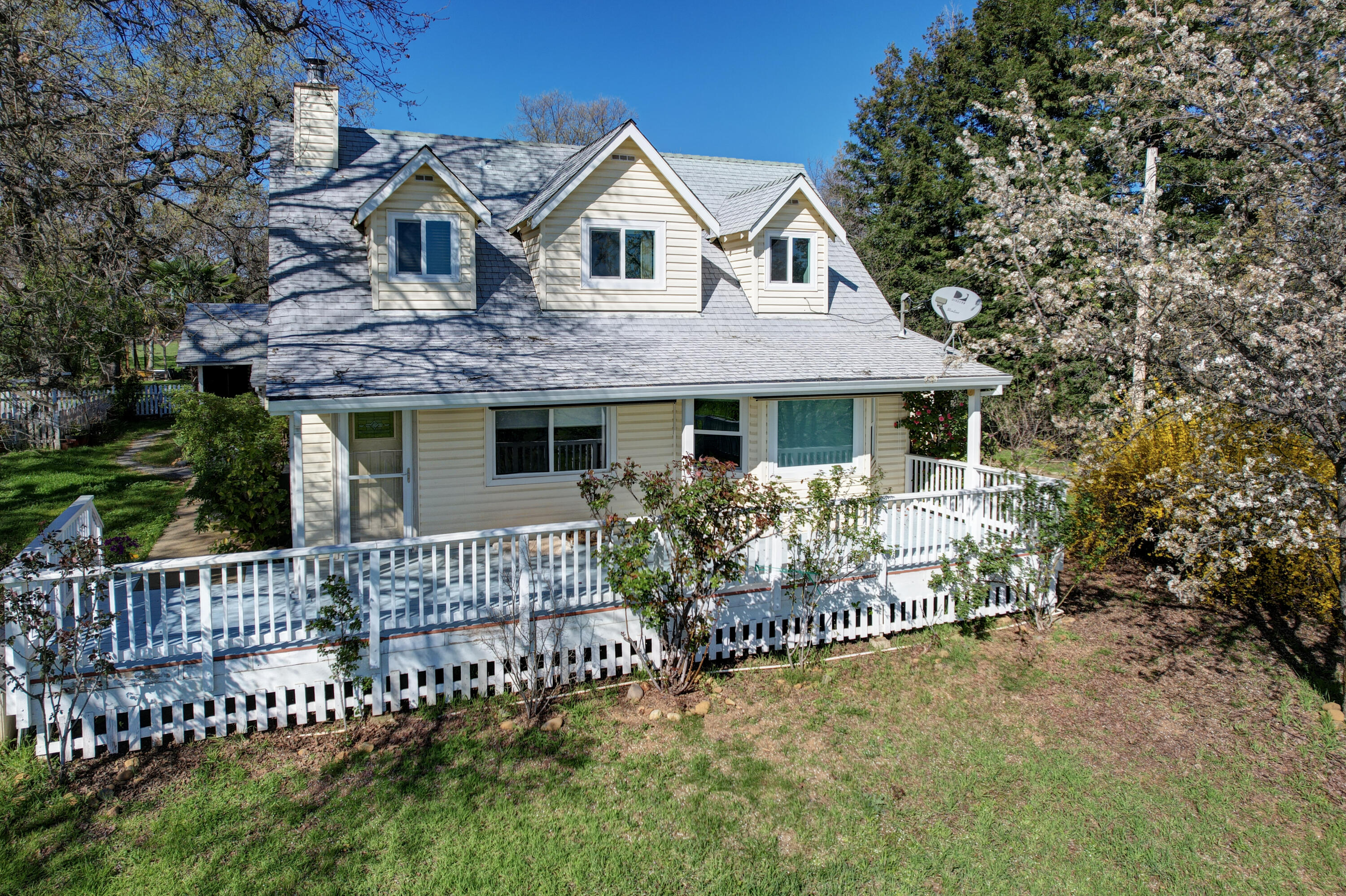 10241 Deschutes Road Palo Cedro, CA 96073 - Photo 55 of 56 a front view of a house with a garden