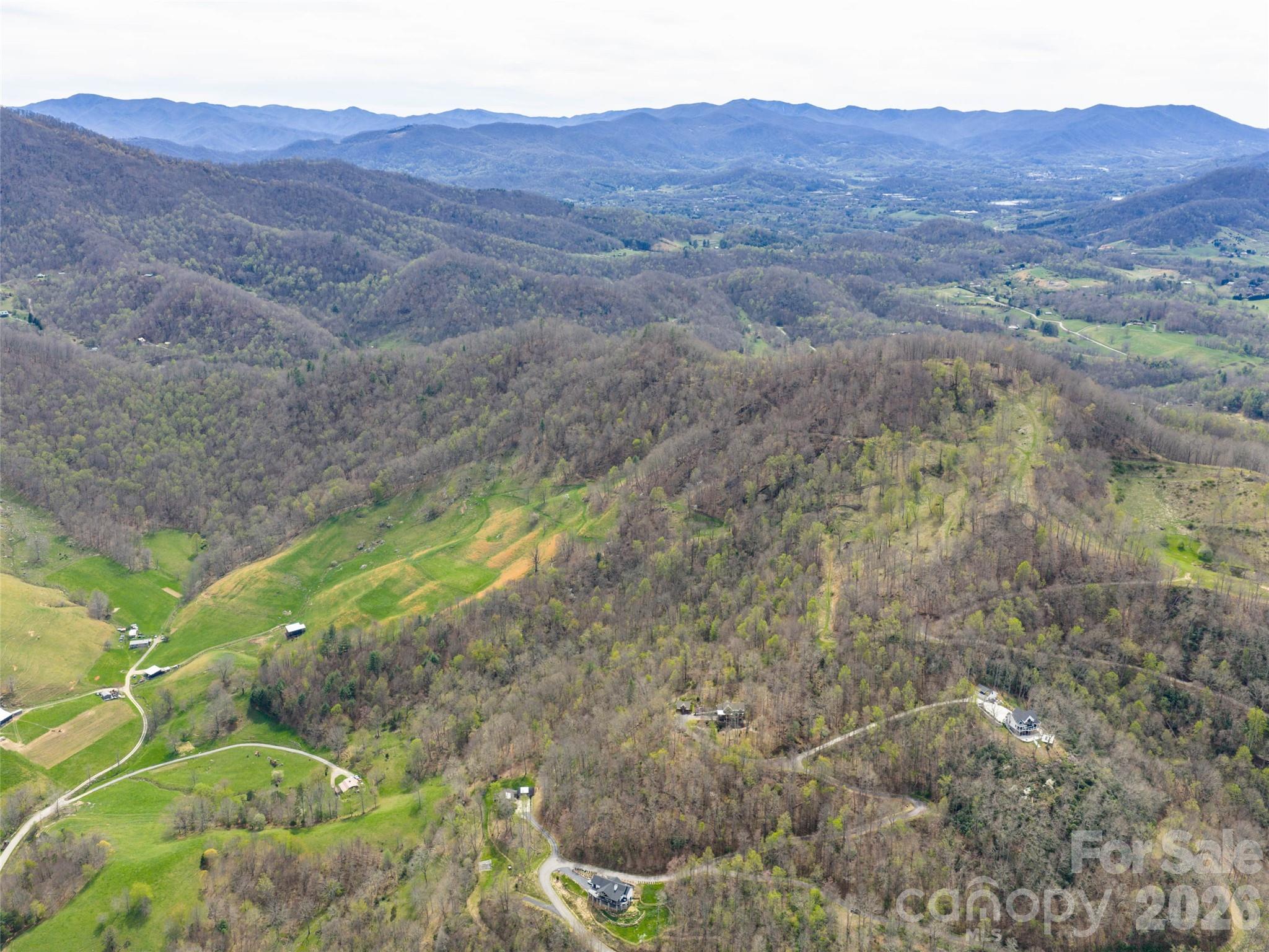 0 Winfield Drive Clyde, NC 28721 - Photo 3 of 10 a view of a house with a mountain and a forest