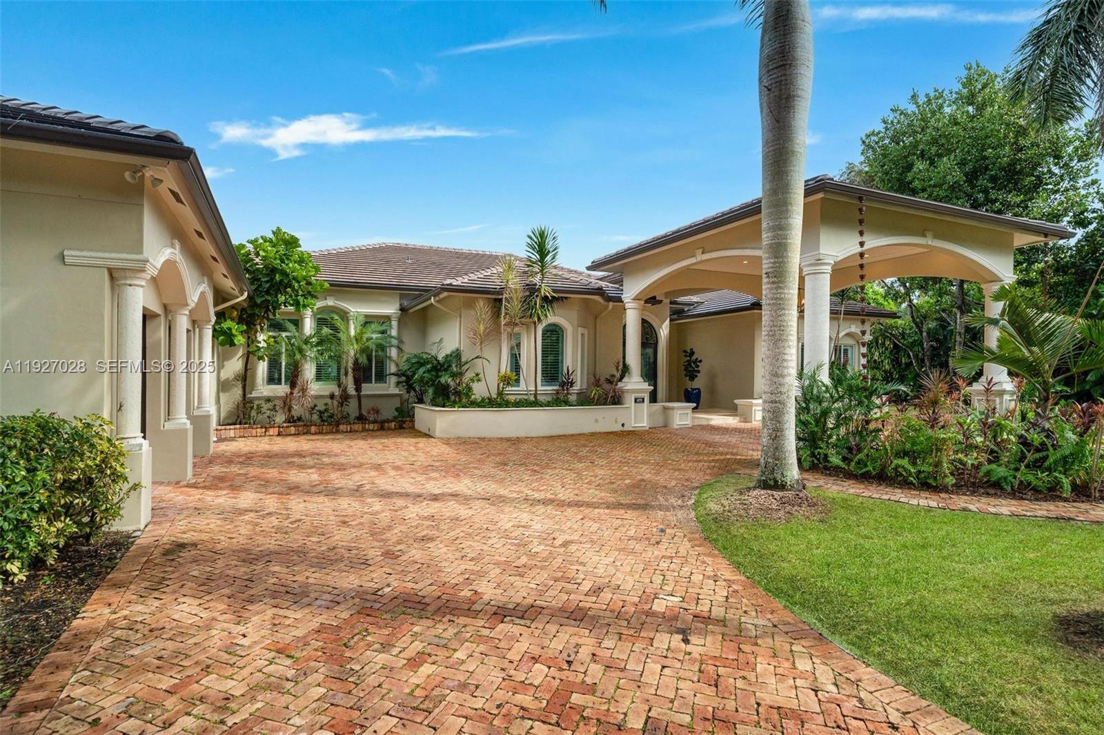 6890 Southwest 94th Street Pinecrest, FL 33156 - Photo 14 of 94 a front view of a house with a yard and potted plants