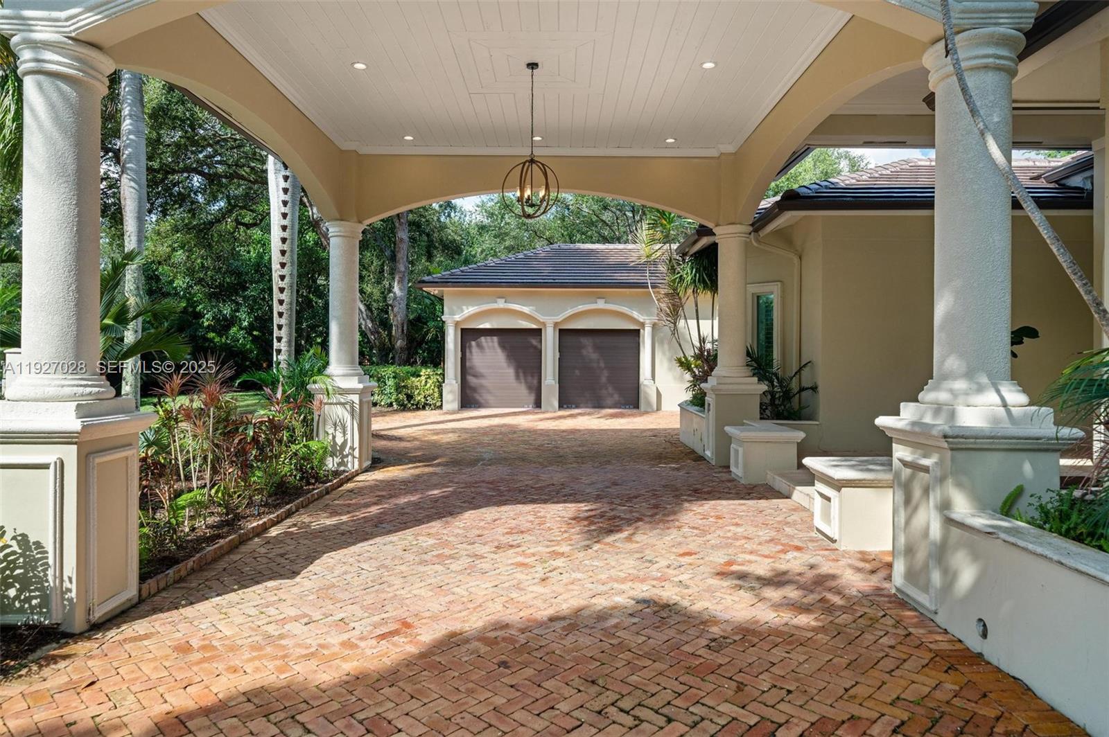 6890 Southwest 94th Street Pinecrest, FL 33156 - Photo 18 of 94 a front view of a house with a porch