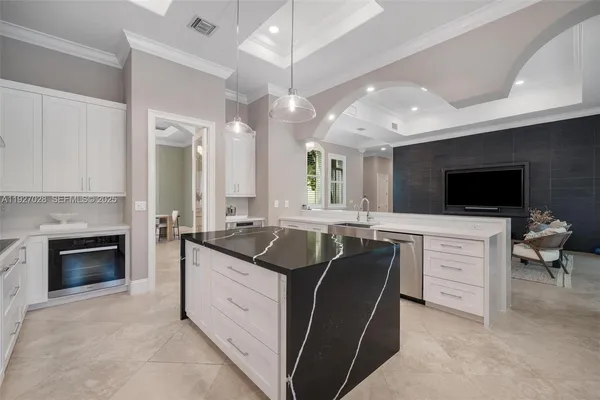 a kitchen with cabinets and chairs