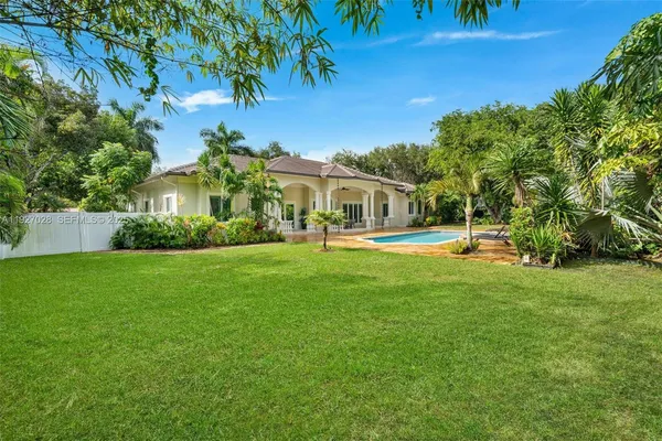 an aerial view of residential house with outdoor space and swimming pool
