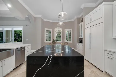 a kitchen with cabinets and chairs