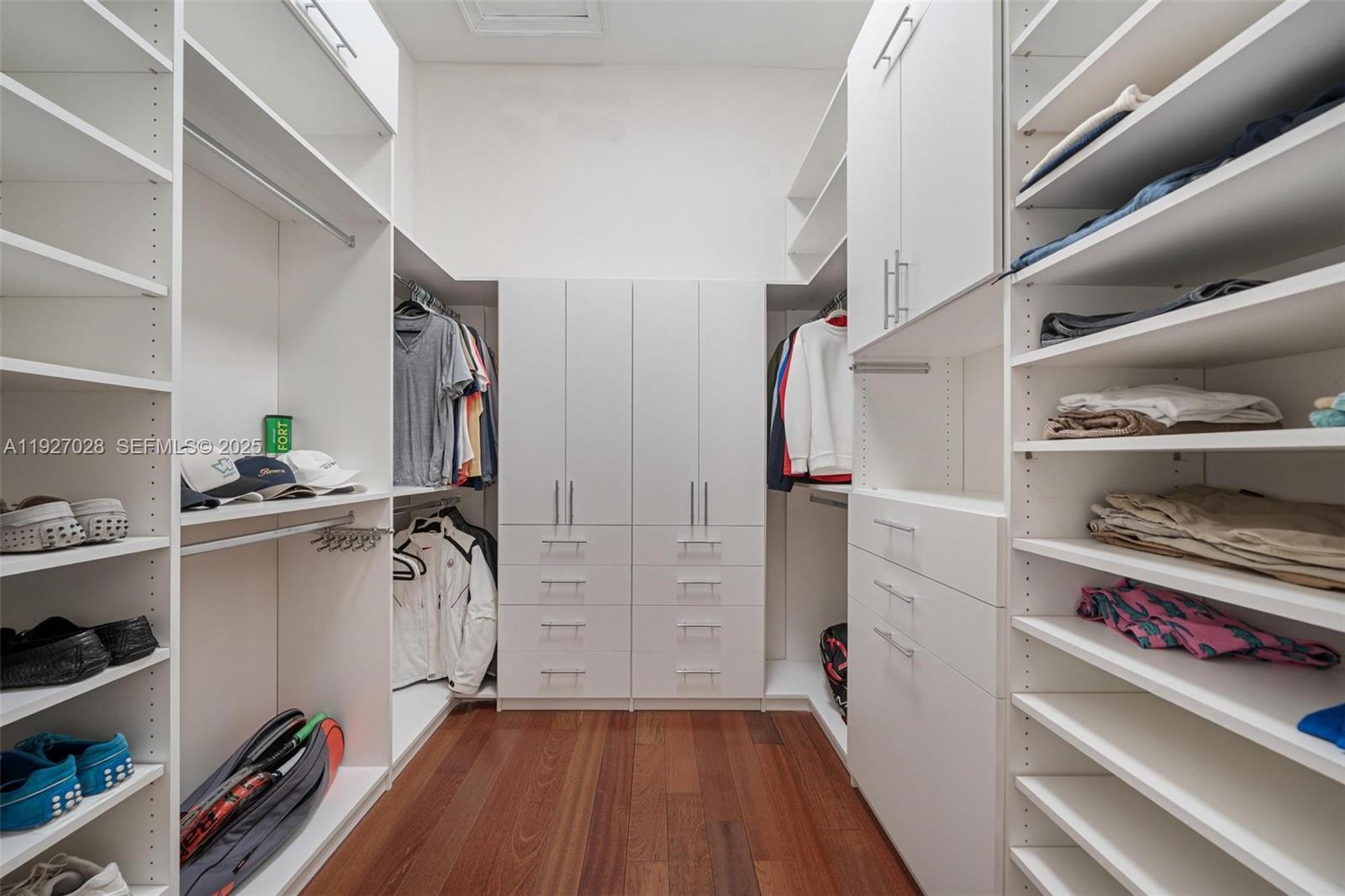 6890 Southwest 94th Street Pinecrest, FL 33156 - Photo 55 of 94 a view of walk in closet with clothes and shoes