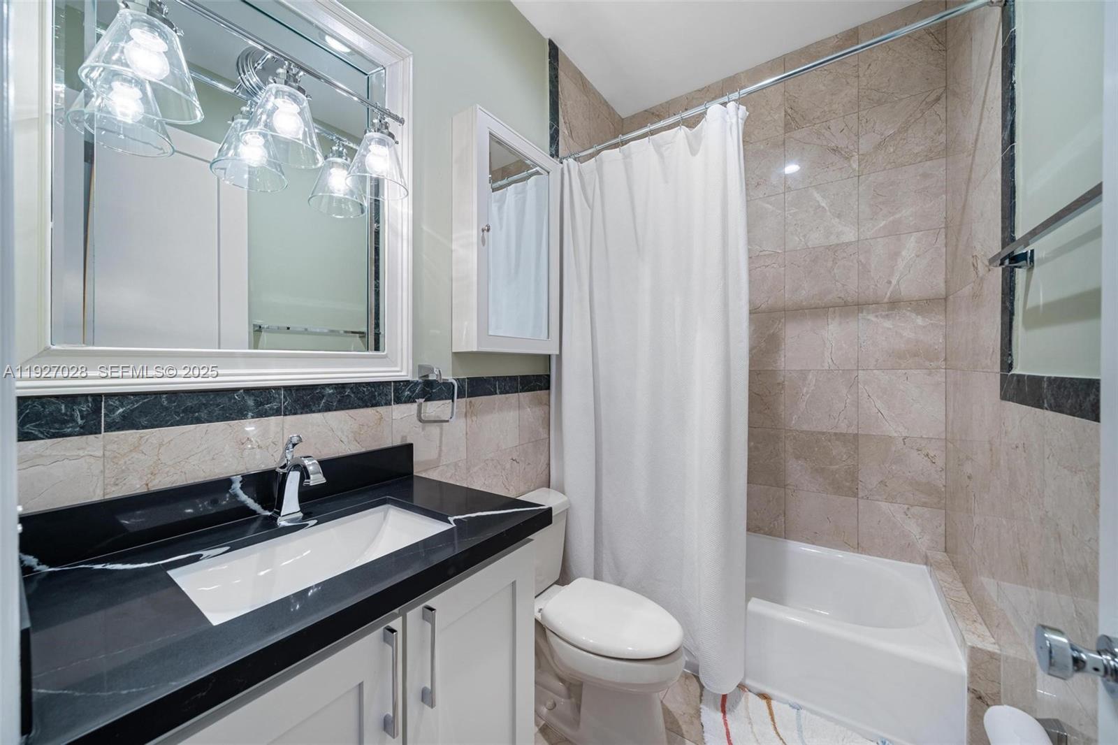 6890 Southwest 94th Street Pinecrest, FL 33156 - Photo 68 of 94 a bathroom with a sink a toilet a mirror and shower