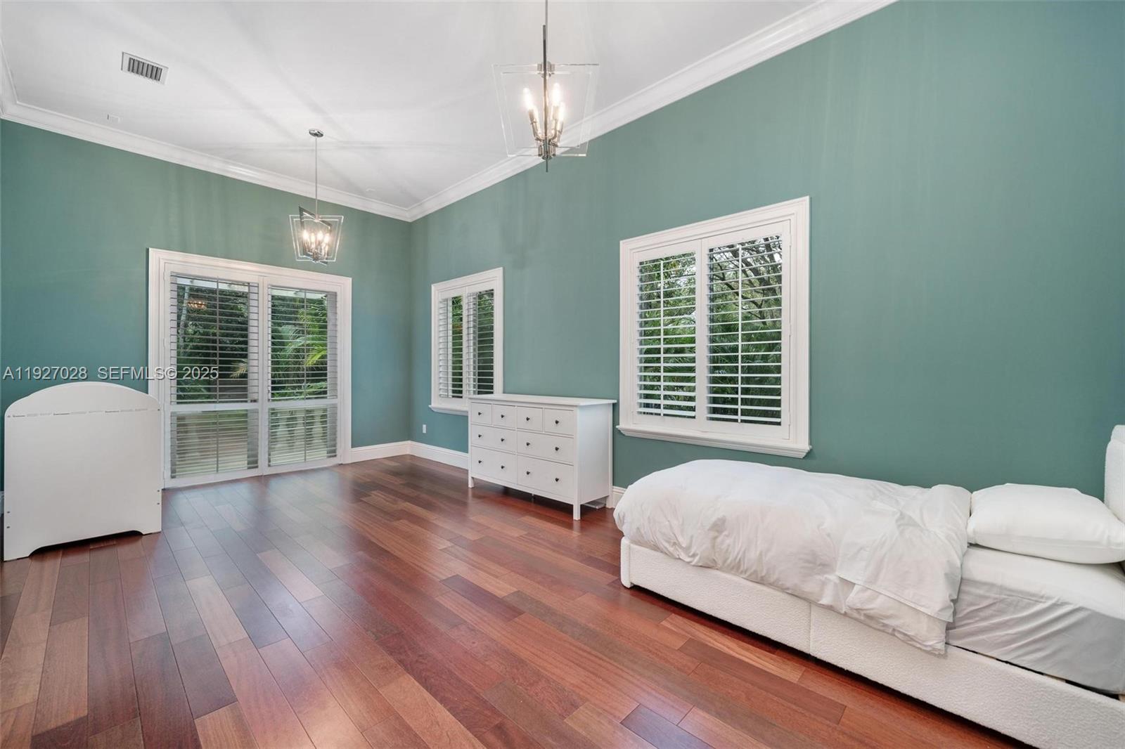 6890 Southwest 94th Street Pinecrest, FL 33156 - Photo 70 of 94 a bedroom with a bed and large window