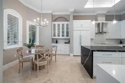 a front view of a house with a yard and potted plants