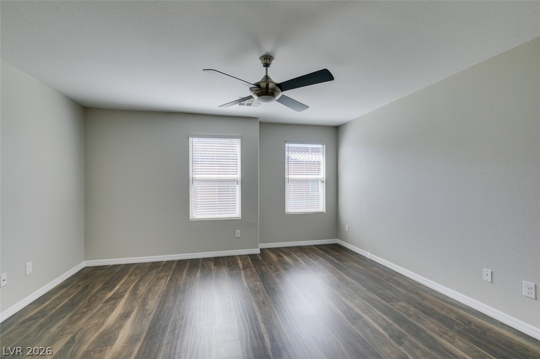 4650 Ranch House Road, Unit 46 North Las Vegas, NV 89031 - Photo 25 of 38 Rich wood-look flooring and clean lines define this versatile modern bedroom.