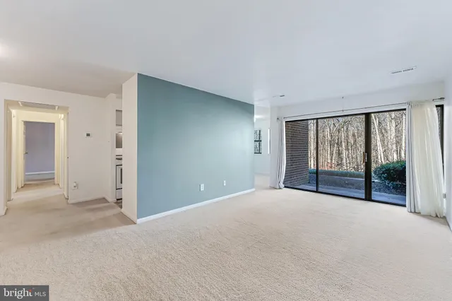 a view of an empty room with glass door
