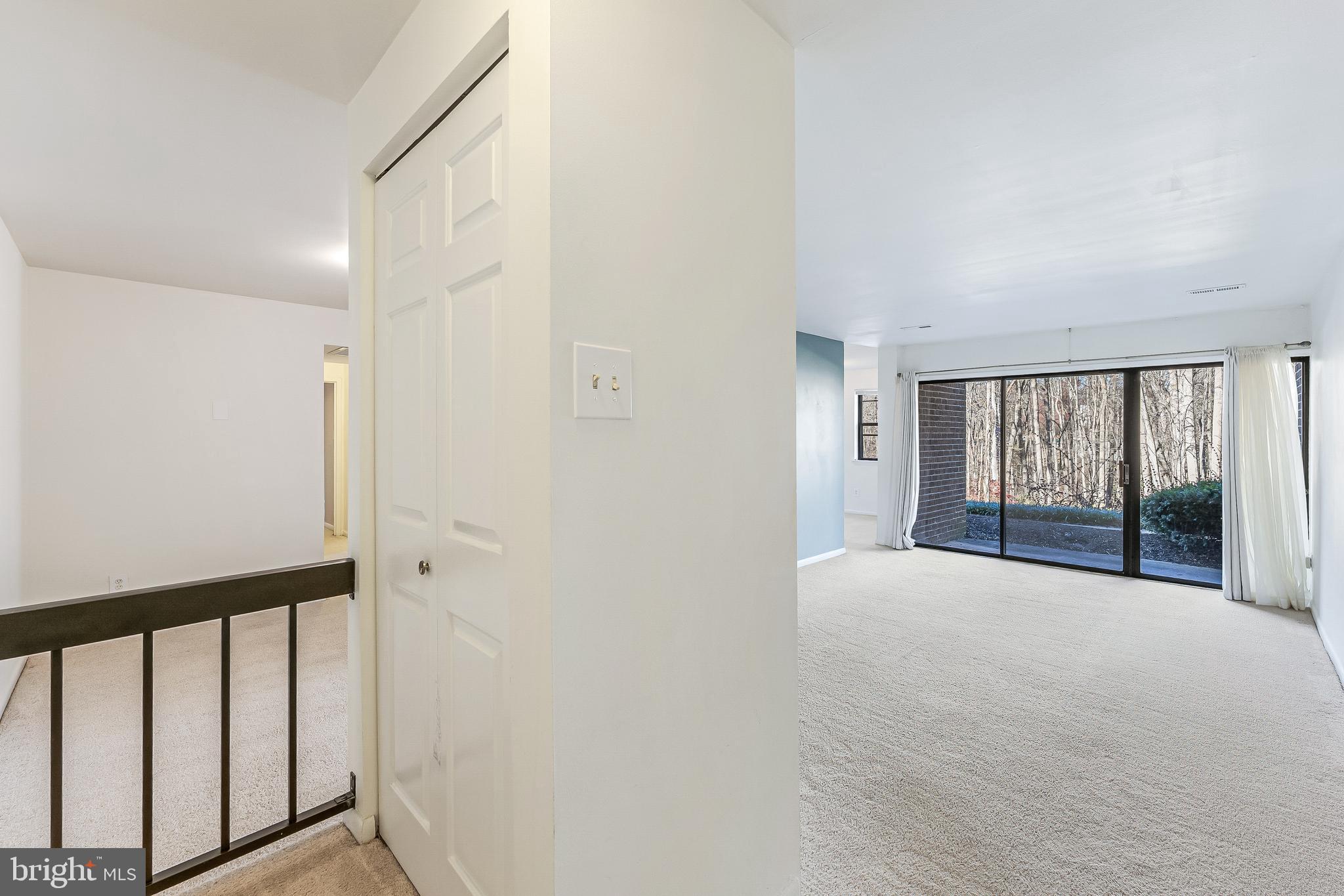 11240 Chestnut Grove Square, Unit 31 Reston, VA 20190 - Photo 13 of 34 a view of an empty room with wooden floor and a window