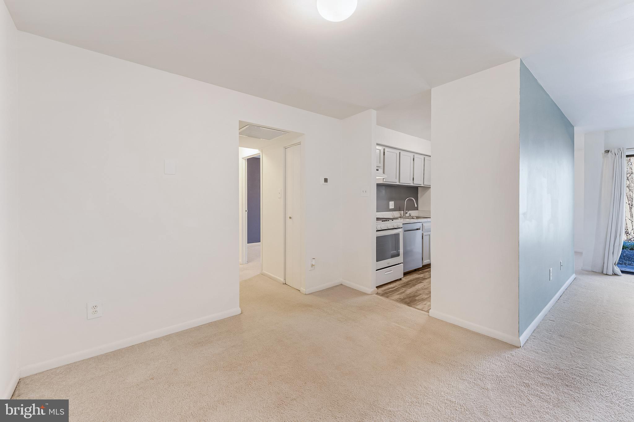 11240 Chestnut Grove Square, Unit 31 Reston, VA 20190 - Photo 14 of 34 an empty room with a kitchen and a sink
