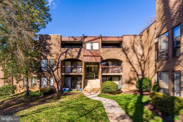 a view of a brick building next to a yard
