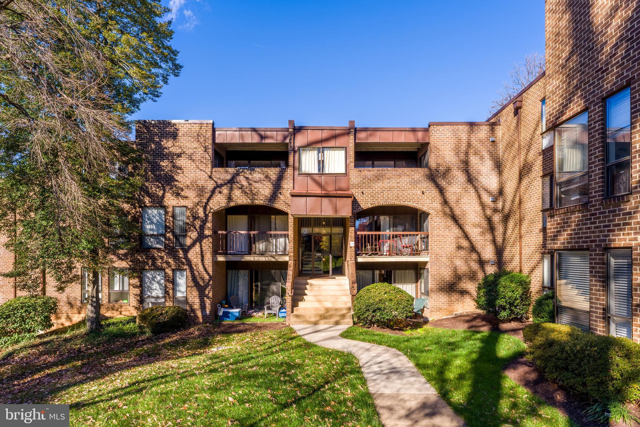 11240 Chestnut Grove Square, Unit 31 Reston, VA 20190 - Photo 31 of 34 a view of a building with a yard