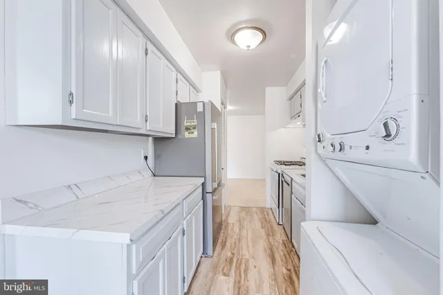 a kitchen with a sink a stove and cabinets