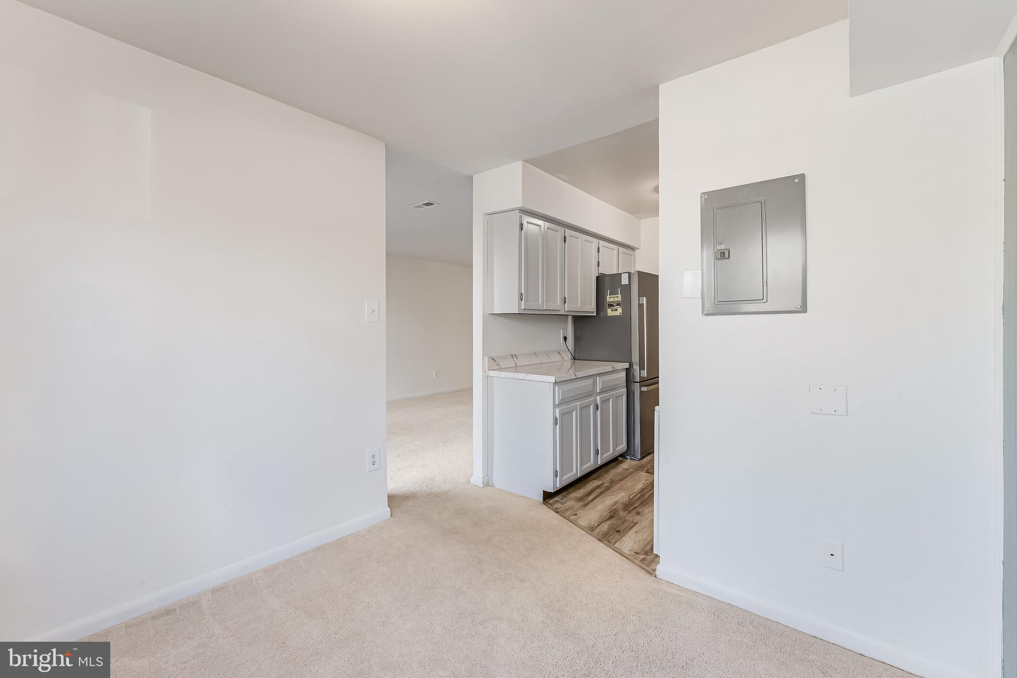 11240 Chestnut Grove Square, Unit 31 Reston, VA 20190 - Photo 7 of 34 a kitchen with cabinets and wooden floor