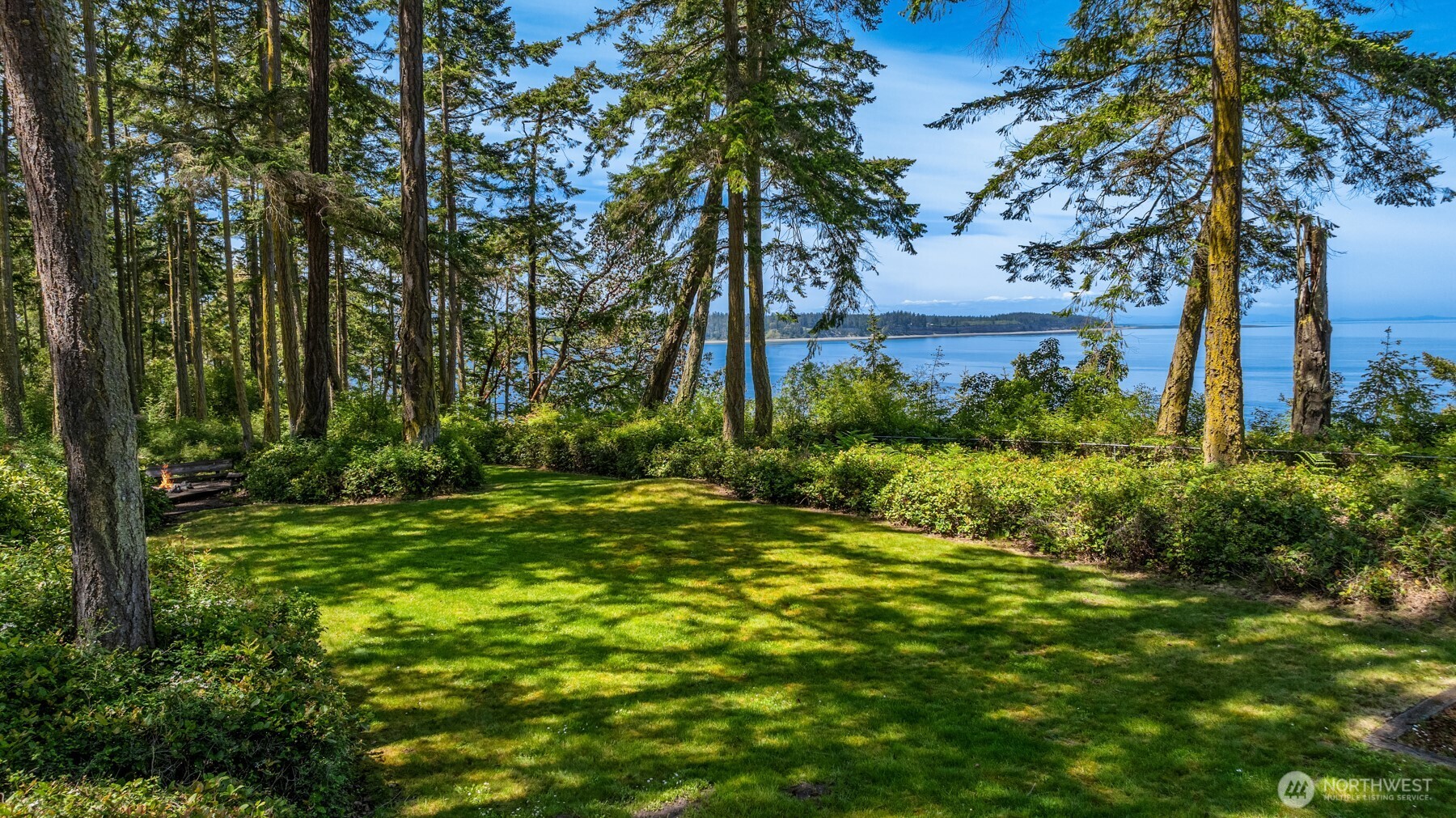 4065 East Sequim Bay Road, Unit 12 Sequim, WA 98382 - Photo 4 of 40 a view of a backyard with large trees
