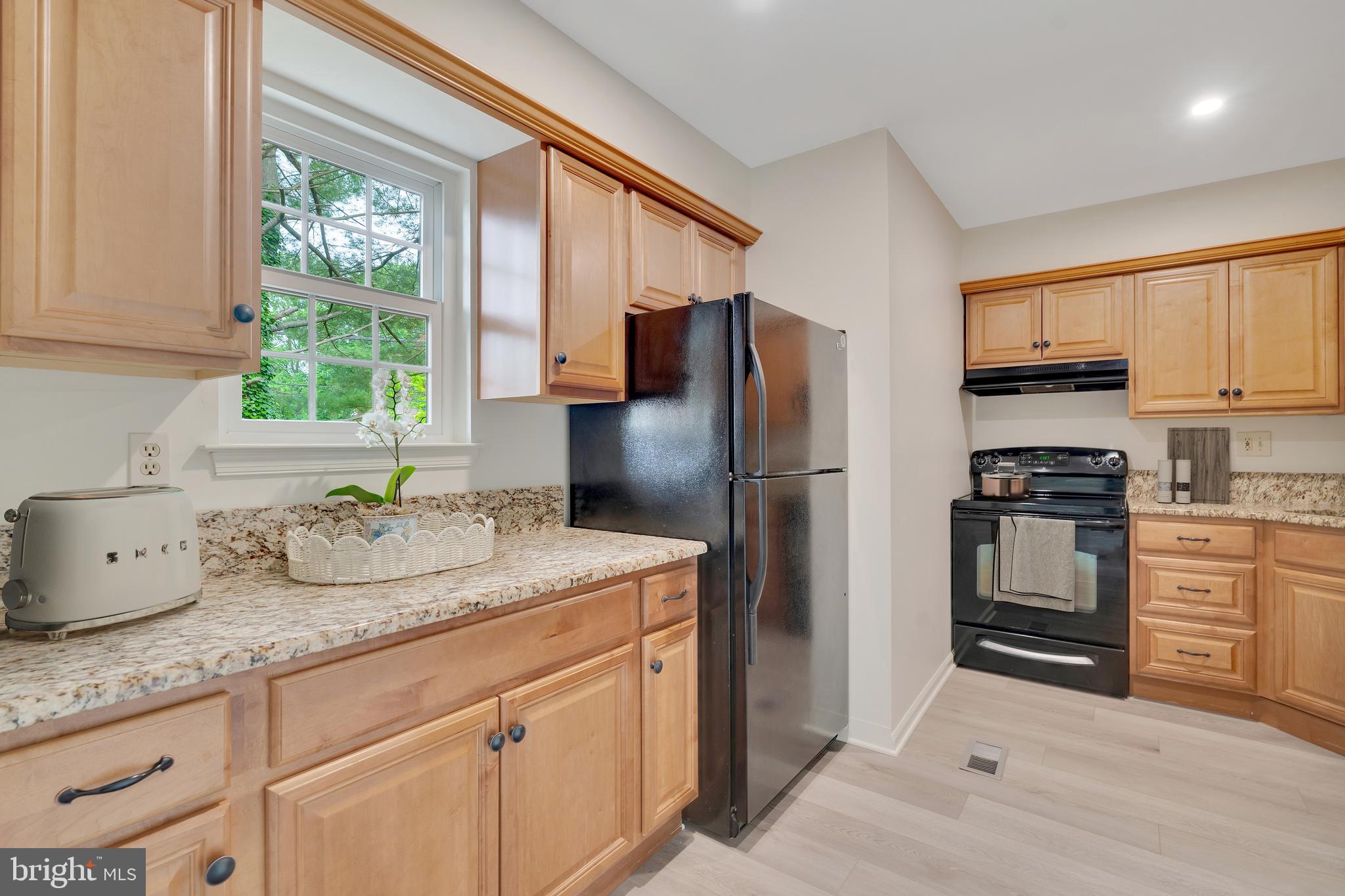431 Eagle Road, Unit 16 Wayne, PA 19087 - Photo 4 of 48 a kitchen with granite countertop a sink stainless steel appliances and cabinets