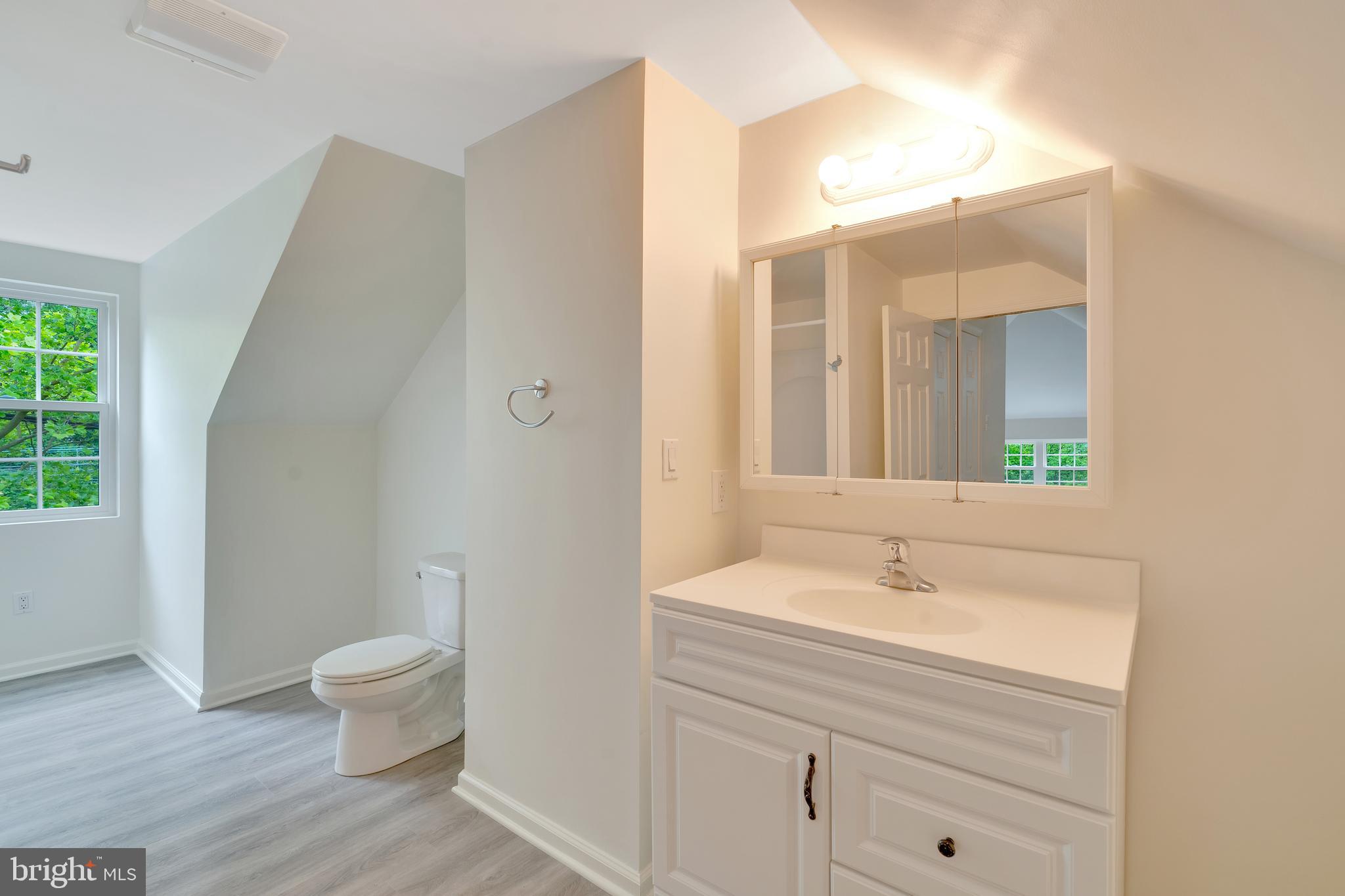 431 Eagle Road, Unit 16 Wayne, PA 19087 - Photo 42 of 48 a bathroom with a sink a toilet and a large mirror