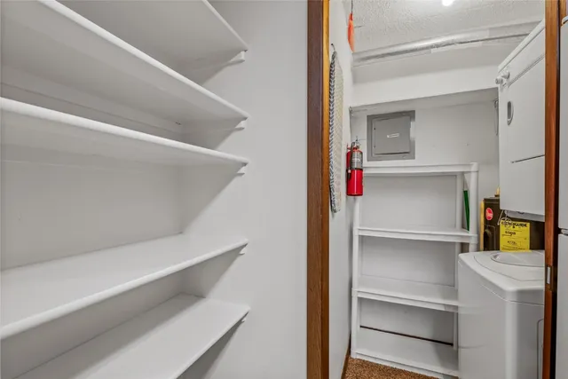 a view of walk in closet with empty racks