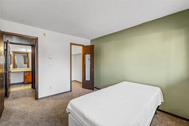 a bedroom with a bed and a cabinets