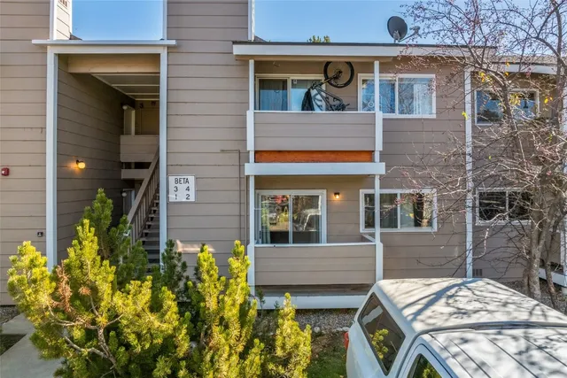 a view of a brick house with large windows