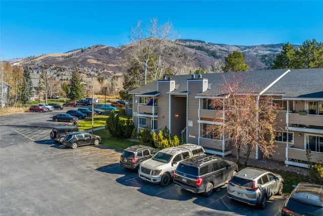 a car parked in front of a brick house