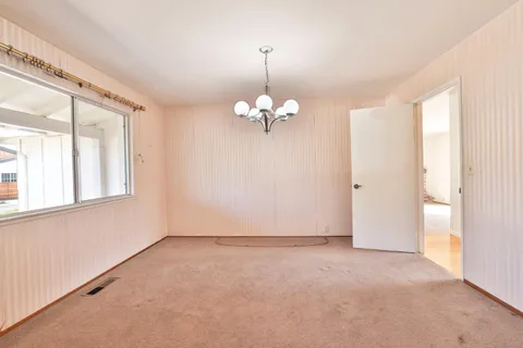 a view of a chandelier in big room and chandelier