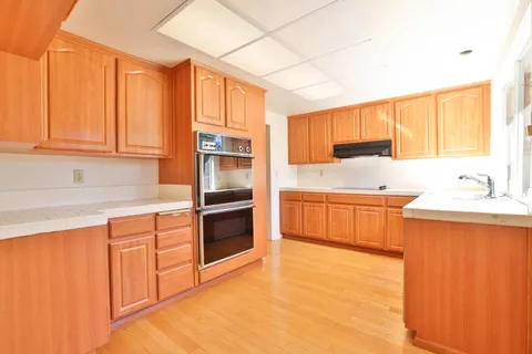 a kitchen with stainless steel appliances a refrigerator sink and cabinets